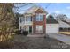 Brick and siding two-story house with green shutters and attached garage at 8018 Trotter Rd, Charlotte, NC 28216