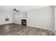 Living room with fireplace and wood-look flooring at 8018 Trotter Rd, Charlotte, NC 28216