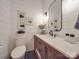 Modern bathroom with wood vanity, white quartz countertop, and frameless mirror at 8100 Avanti Dr, Waxhaw, NC 28173