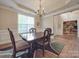 Formal dining room with hardwood floors, chandelier, and access to kitchen at 8100 Avanti Dr, Waxhaw, NC 28173