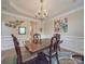 Elegant dining room features a dark wood table, chandelier, and wall art at 8100 Avanti Dr, Waxhaw, NC 28173