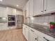 Bright kitchen boasts white cabinets, granite countertops, and stainless steel appliances at 8100 Avanti Dr, Waxhaw, NC 28173