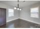 Bright dining room with dark hardwood floors and elegant light fixture at 811 Colonial Dr, Rock Hill, SC 29730