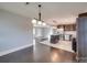 Open dining area with hardwood floors and view of the kitchen at 811 Colonial Dr, Rock Hill, SC 29730