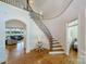 Elegant two-story entryway with curved staircase and hardwood floors at 8191 Deep Water Ln, Denver, NC 28037