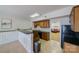 Basement kitchenette with dark wood cabinets and granite counters at 8191 Deep Water Ln, Denver, NC 28037