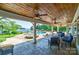 Covered patio with seating area overlooking pool and lake at 8191 Deep Water Ln, Denver, NC 28037