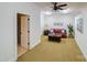 Basement sitting area with red leather couch and adjacent bathroom at 8191 Deep Water Ln, Denver, NC 28037