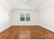 Bright bedroom with hardwood floors and ceiling fan at 8406 Tifton Rd, Charlotte, NC 28226