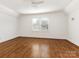 Spacious bedroom with hardwood floors and two windows at 8406 Tifton Rd, Charlotte, NC 28226