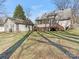 Home's back view, showcasing a deck, garage, and yard at 8406 Tifton Rd, Charlotte, NC 28226