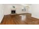 Spacious living room with hardwood floors and a brick fireplace at 8406 Tifton Rd, Charlotte, NC 28226