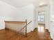 Upstairs hall with wood railing and hardwood floors at 8406 Tifton Rd, Charlotte, NC 28226