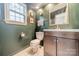 Charming bathroom with dark vanity and green walls at 8708 Sweet Sage Ln, Charlotte, NC 28227