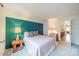 Bedroom with a teal accent wall, double bed and access to the upper floor at 8708 Sweet Sage Ln, Charlotte, NC 28227