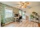 Home office with leafy wallpaper, built-in shelving and hardwood floors at 8708 Sweet Sage Ln, Charlotte, NC 28227