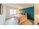 Bedroom with a teal accent wall, double bed and ample closet space at 8708 Sweet Sage Ln, Charlotte, NC 28227