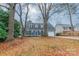 Two story house with gray siding, blue door, and landscaping, seen from across the yard at 8708 Sweet Sage Ln, Charlotte, NC 28227