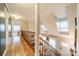 Upstairs hallway with hardwood floors and a view of the living area at 8708 Sweet Sage Ln, Charlotte, NC 28227