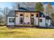 Stylish white exterior, covered porch, and beautiful landscaping at 910 S College Ave, Newton, NC 28658