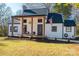 Renovated farmhouse with a charming front porch and American flag at 910 S College Ave, Newton, NC 28658