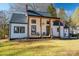 Charming farmhouse-style home with white siding, covered porch, and manicured lawn at 910 S College Ave, Newton, NC 28658