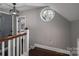 Upper hallway with wood floors, circular window, and access to bedrooms at 910 S College Ave, Newton, NC 28658