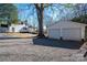 White house with detached two-car garage and gravel driveway at 910 S College Ave, Newton, NC 28658