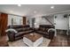 Bright living area features a bay window and leather sofas at 910 S College Ave, Newton, NC 28658