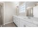 Bright bathroom featuring double vanity with white countertop and modern fixtures at 9223 Belcaro Ln, Charlotte, NC 28273