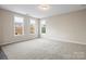 Bright bedroom featuring neutral walls and large windows with pleasant outdoor views at 9223 Belcaro Ln, Charlotte, NC 28273