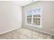 Bright, carpeted bedroom with a large window allowing ample natural light at 9223 Belcaro Ln, Charlotte, NC 28273