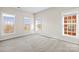 Bedroom featuring neutral walls, carpeted floors, and three large windows at 9223 Belcaro Ln, Charlotte, NC 28273