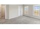 Bedroom featuring neutral walls, carpeted floors, and two large windows at 9223 Belcaro Ln, Charlotte, NC 28273