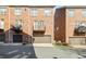 Brick townhomes with attached garages and small balconies above at 9223 Belcaro Ln, Charlotte, NC 28273