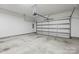 Clean, well-lit two car garage with white door and concrete floor at 9223 Belcaro Ln, Charlotte, NC 28273