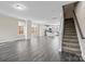 Bright living room leading to the open concept kitchen and staircase access at 9223 Belcaro Ln, Charlotte, NC 28273