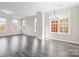 Spacious living room featuring many windows and sleek gray laminate flooring at 9223 Belcaro Ln, Charlotte, NC 28273