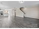 Open-concept living room and kitchen featuring modern finishes and an open staircase at 9223 Belcaro Ln, Charlotte, NC 28273