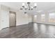 Open-concept living room featuring sleek laminate flooring and access to the second story at 9223 Belcaro Ln, Charlotte, NC 28273