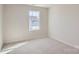 Well-lit bedroom featuring a large window and carpeted floor at 9858 Old Garden Cir, Gastonia, NC 28056