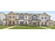 Four-unit townhome building with neutral siding and landscaping at 9858 Old Garden Cir, Gastonia, NC 28056