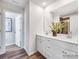 Double vanity bathroom with white cabinets and a walk-in shower at 9862 Old Garden Cir, Gastonia, NC 28056