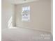 Bright bedroom with neutral tones, carpet, and a window at 9862 Old Garden Cir, Gastonia, NC 28056