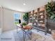 Home office with a wooden desk, metal shelving, and comfortable seating at 9862 Old Garden Cir, Gastonia, NC 28056