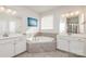 Large bathroom with double vanity and corner soaking tub at 11618 Macallano Dr, Charlotte, NC 28215