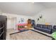 Spacious bonus room with a sectional sofa and hardwood floors at 11618 Macallano Dr, Charlotte, NC 28215