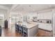Modern kitchen with granite island, stainless steel appliances, and hardwood floors at 11618 Macallano Dr, Charlotte, NC 28215