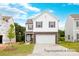 Two-story home with gray and white exterior, stone accents, and a two-car garage at 12009 Garmon Mill Estates Dr # 2P, Stanfield, NC 28163