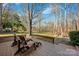 Wooden deck overlooking backyard with two chairs at 12749 Netherhall Dr, Charlotte, NC 28269